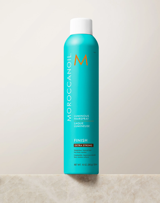 Moroccanoil hair spray bottle on a light background