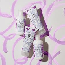 Set of skincare products with visible branding on a patterned background. Bumble and Bumble Curl Butter Hair Mask 6.7oz jar, rich mask that deeply nourishes, defines curls, reduces frizz, and enhances softness, shine, and curl elasticity