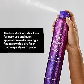 Purple hairspray bottle held by a hand with text about the twist-lock nozzle. Bumble and Bumble Spray de Mode Flexible Hold Hairspray 10oz can, lightweight styling spray that provides flexible hold, natural movement, and shine.