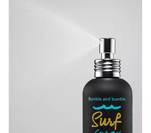 Bumble and bumble surf spray bottle on a gray background