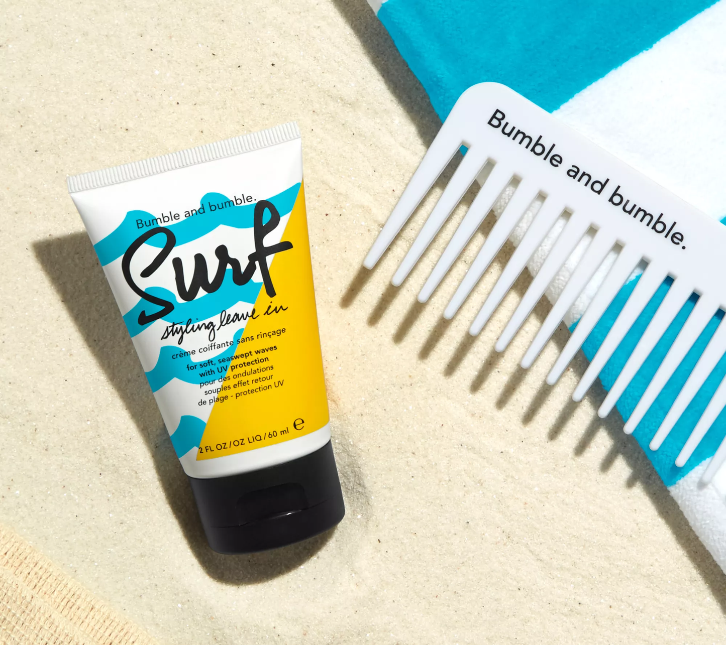 Bumble and bumble Surf styling leave-in product with a comb on a beige background. Bumble and Bumble Surf Styling Leave-In 2oz bottle, lightweight leave-in treatment that adds texture, volume, and beachy waves while enhancing softness and shine