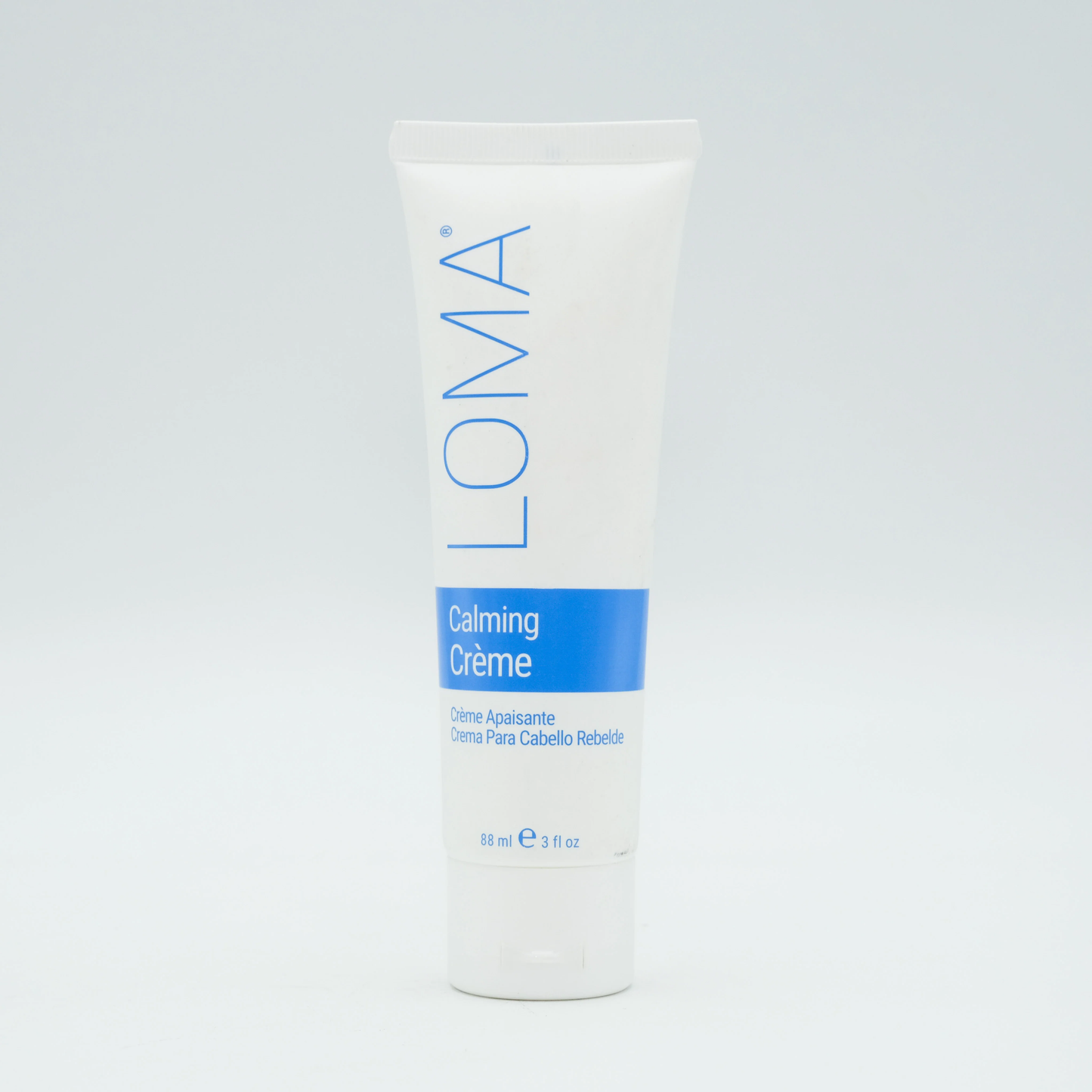 Loma Calming Creme container on a light gray background. Loma Calming Creme 3oz jar, soothing hair treatment that calms the scalp, nourishes strands, and restores softness, moisture, and manageability.