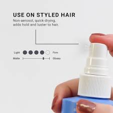 Hand holding a hair spray bottle with text on styled hair use and product features.Loma Firm Hold Hair Spray 8oz can, professional hairspray that provides strong, long-lasting hold, controls flyaways, and leaves hair smooth and flexible