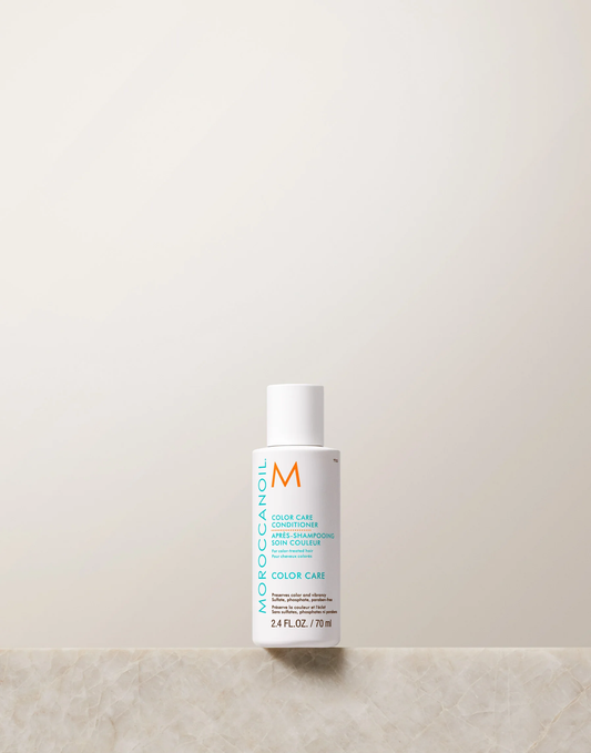 Moroccanoil bottle on a light beige background