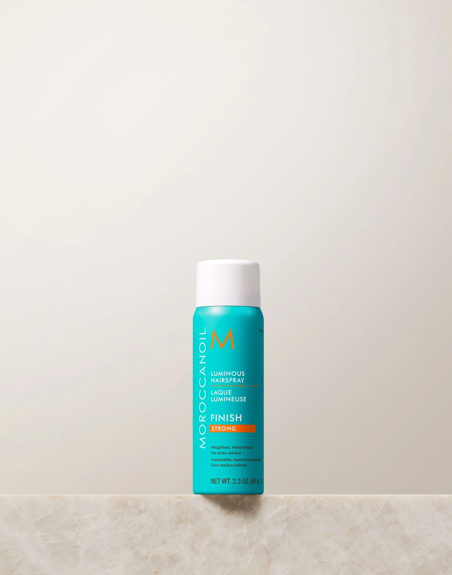 Moroccanoil bottle on a light beige background