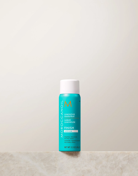 Moroccanoil bottle on a light beige background