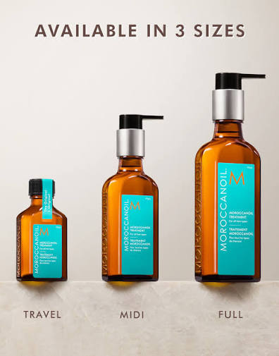 Three bottles of Moroccanoil hair care products on a beige background with text indicating sizes.