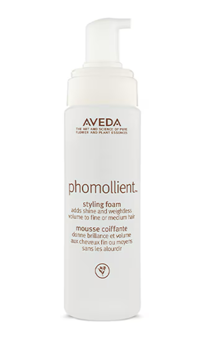 Aveda phomollient styling foam bottle on a white background. Aveda Phomollient Styling Foam bottle, lightweight mousse that adds body, volume, and flexible hold while smoothing and enhancing natural shine.