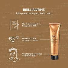 Brilliantine styling cream packaging with branding and product details on a brown background