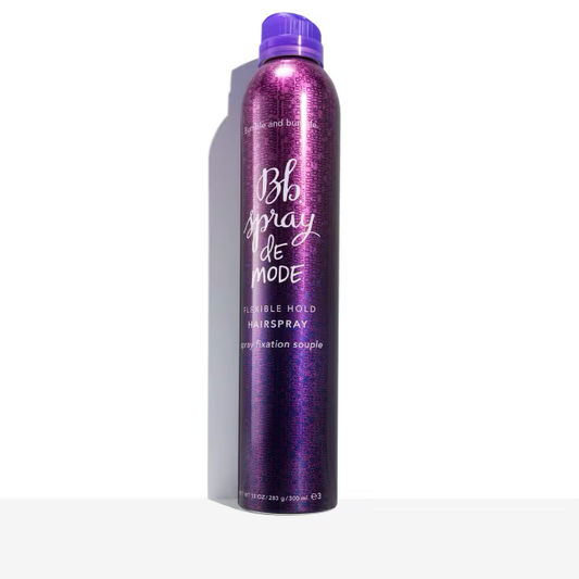 Purple hairspray can with 'Bb spray de mode' text on a white background.Bumble and Bumble Spray de Mode Flexible Hold Hairspray 10oz can, lightweight styling spray that provides flexible hold, natural movement, and shine.