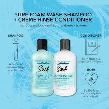 Two bottles of Surf surf foam wash shampoo and crème rinse conditioner on a blue background with product details.