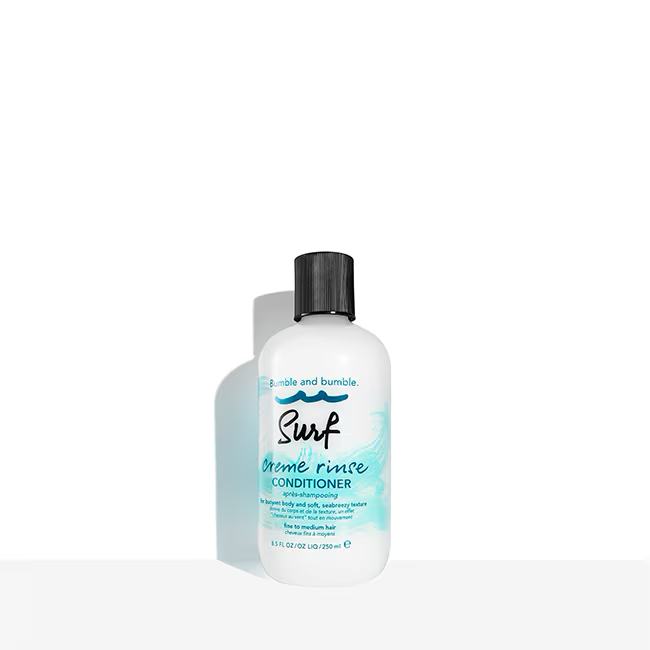 Bumble and bumble Surf brine rinse conditioner bottle on a white background. Bumble and Bumble Surf Creme Rinse Conditioner 8.5oz bottle, lightweight conditioner that hydrates hair, enhances texture, and creates soft, beachy waves with natural movement.