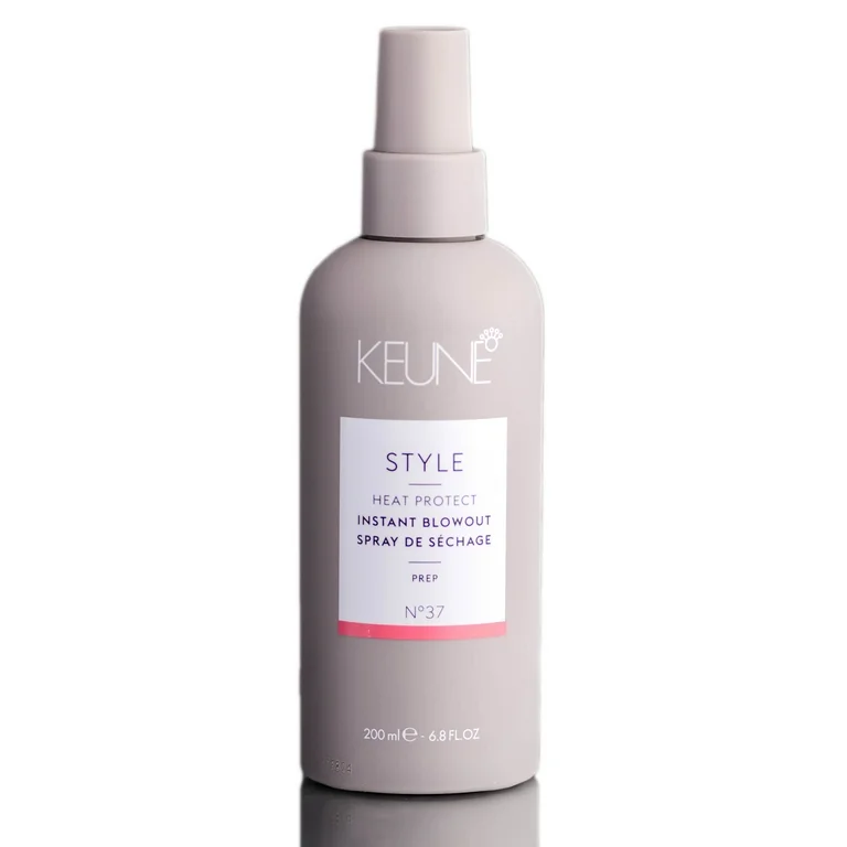 Keune hair care product bottle on a white background. Keune Style Heat Protect Instant Blowout Spray 6.8oz bottle, lightweight spray that protects hair from heat while smoothing and adding shine during blowouts.