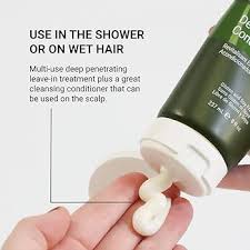 Hand holding a green and white bottle with a pump, with text about its use in the shower or on wet hair.Loma Deep Conditioner 8oz jar, intensive hair treatment that hydrates, strengthens, and restores softness and shine to all hair types