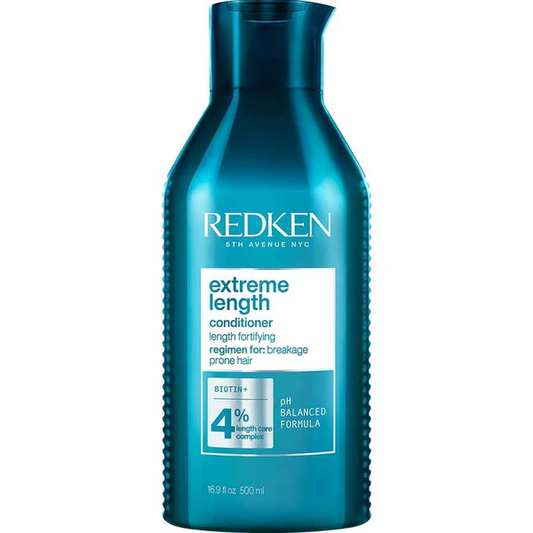 Blue bottle of Redken Extreme Length conditioner on a white background. A 16.9oz (500ml) bottle of Redken Extreme Length Conditioner featuring the signature light blue packaging with pump top, labeled with biotin and strengthening benefits.